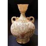 A Royal Worcester ovoid vase, in blush ivory, decorated in gilt and pink with scrolling foliage,