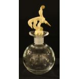 A decanter designed by Jean Boggio, France, the moulded resin stopper as a performing clown, clear