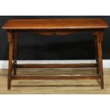 An Arts & Crafts oak serving table or centre table, moulded rounded rectangular top, shaped