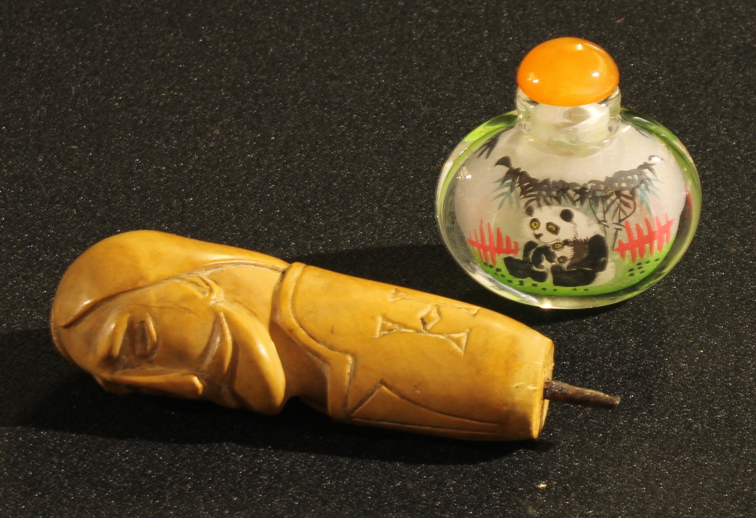 A Chinese snuff bottle, inside painted with pandas; a 19th century continental boxwood cane handle