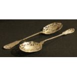 A pair of Victorian silver pierced fruit spoons, the bowls engraved with pineapple, peaches and