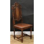 A late Victorian oak hall chair, of William and Mary design, shaped and pierced cresting carved with