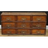 An early 20th century oak 'notary' filing cabinet, by Stolzenberg, rectangular top above nine doors,