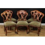 A set of six Victorian walnut and mahogany dining chairs, each with a trefid cresting, stuffed-