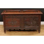 An 18th century oak blanket chest, hinged rectangular top above a blind fretwork frieze carved