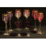 A set of six tulip shaped hock wine glasses, the ribbed bowls in shades of pink and amethyst,