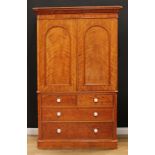 A Victorian satin birch linen press, moulded cornice above a pair of arched panel doors enclosing