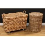 A large wicker log or laundry basket, 71.5cm high overall, 85cm high, 58cm deep, the basket 51cm