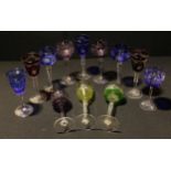 A pair of amethyst flashed hock glasses, engraved with opaque fruiting vine, slender tapering stems,