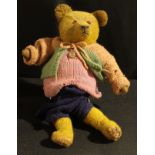 A 1940's straw filled golden mohair teddy bear, amber and black plastic eyes, pronounced snout