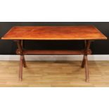 A stained pine X-frame trestle dining refectory table, rectangular top, chamfered supports and