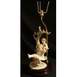 An Italian Giuseppe Armani Florence figural table lamp, as children on a swing, 39cm