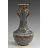 A Chinese Jun ware earthenware bottle vase, glazed in merging mottled tones of blue and purple, with