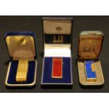 A Dunhill cigarette lighter, Rollagas Rulerlite & Wheatsheaf, in red and gold plate, made in