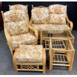 A six piece bamboo conservatory suit, sofa, pair of chairs, foot stool, two glass topped coffee