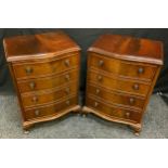 A pair of modern mahogany four drawer serpentine bedside chest, 70cm high, 48cm wide, 37cm deep (2)