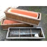 A cast iron rectangular animal feeding trough, 90cm x 32.5cm; a pair of wooden planters (3)