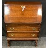 An oak bureau, fall front, fitted interior, secret frieze drawer, turned legs, 103cm high, 74cm