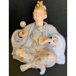 A 19th century bisque porcelain figure, Nodding Head Juggler, modelled with lilac attire painted