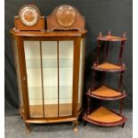 A walnut serpentine single door display cabinet, 109cm high, 76cm wide; a reproduction four tier