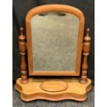 A Victorian arch top mahogany dressing table mirror, turned supports, serpentine base, 56cm high.