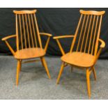 A pair of Ercol Goldsmith elm and beech carver chairs, designed by Lucian R Ercolani.