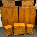 A matched ducal pine eight piece bedroom suite, triple fitted wardrobe, triple hanging wardrobe;