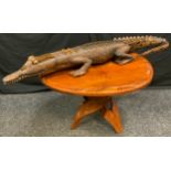 Papua New Guinea side table, collapsible base, 68cm wide; a hardwood crocodile