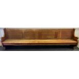 A large 19th century pine pew, scroll arms, 323cm long, late 19th century