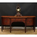 A George III mahogany sideboard or serving table, slightly oversailing top above a central frieze