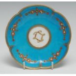 An 18th century shaped circular Sevres saucer, jewelled with flowers on a turquoise ground, 13cm