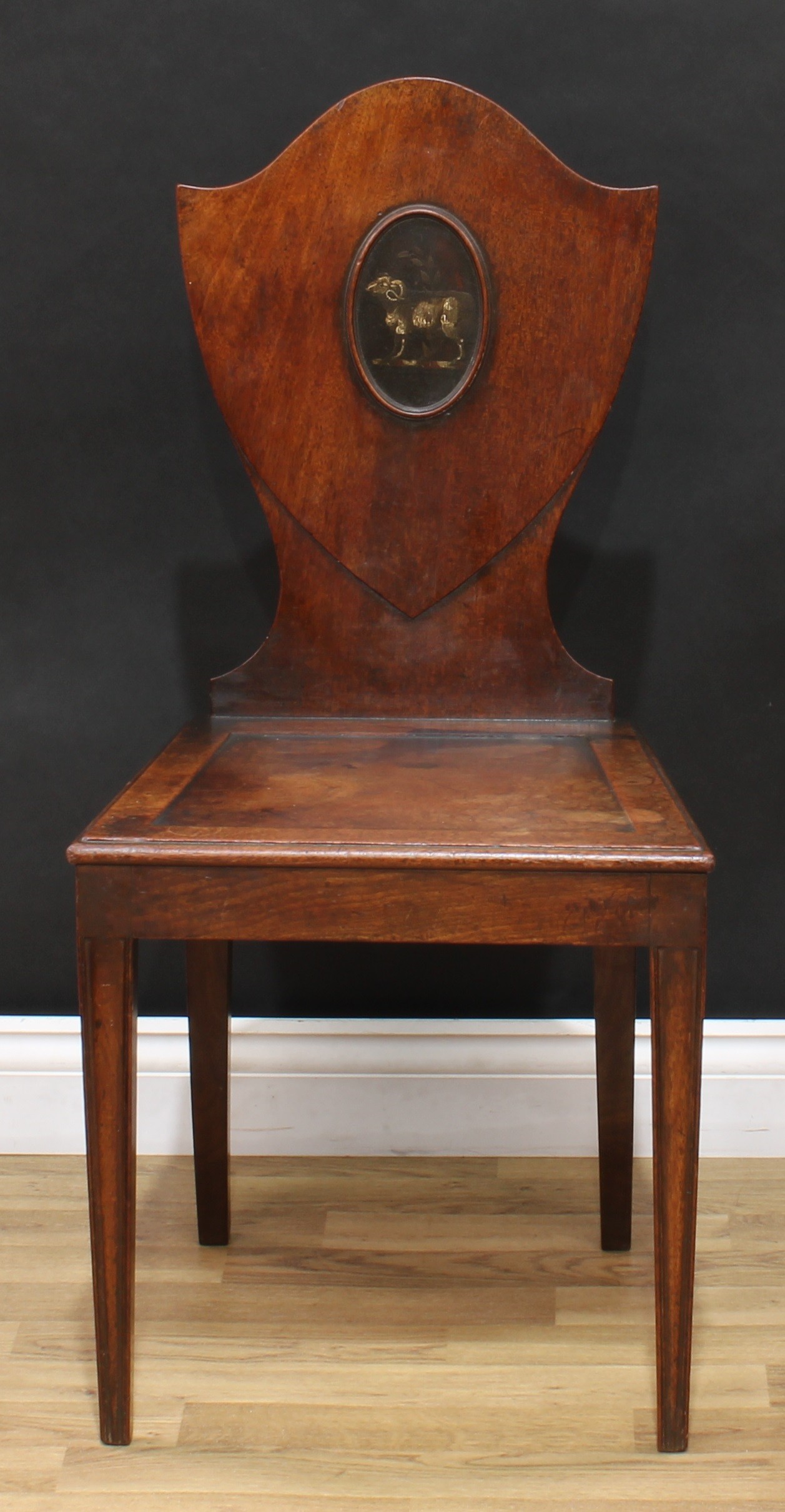 A George III mahogany Heraldic hall chair, shield shaped back with painted oval reserve, panel seat, - Image 2 of 5