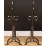 A large pair of unusual country house andirons, each scroll terminating in a horse head, 88cm