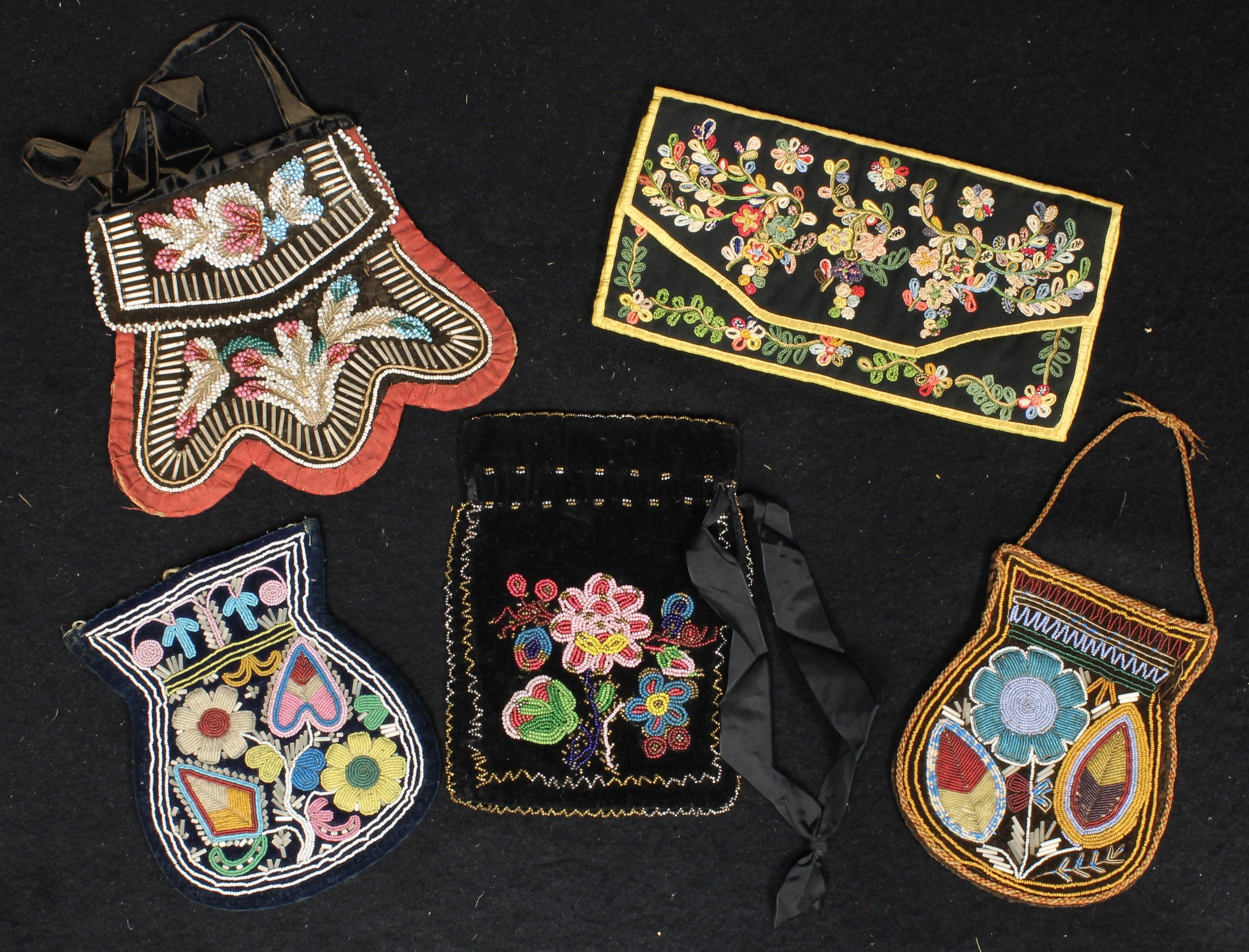 A 19th century beadwork purse, possibly Native America, brightly decorated with stylized flowers and
