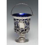 An 18th century silver pedestal sugar basket, pierced and embossed with a trellis of flowers and