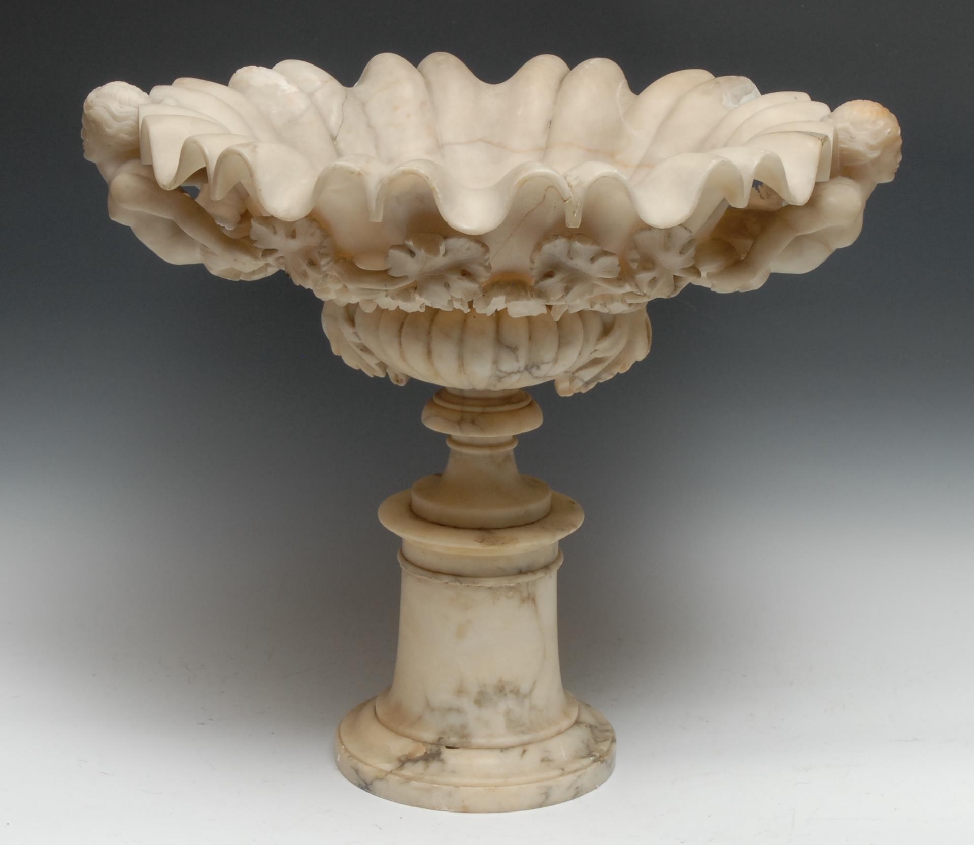A 19th century alabaster sculptural table-centre, half-fluted scallop shell plateau carved with a