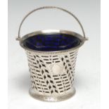 A George III silver swing handled cream basket, pierced and bright-cut engraved with wriggle-work,