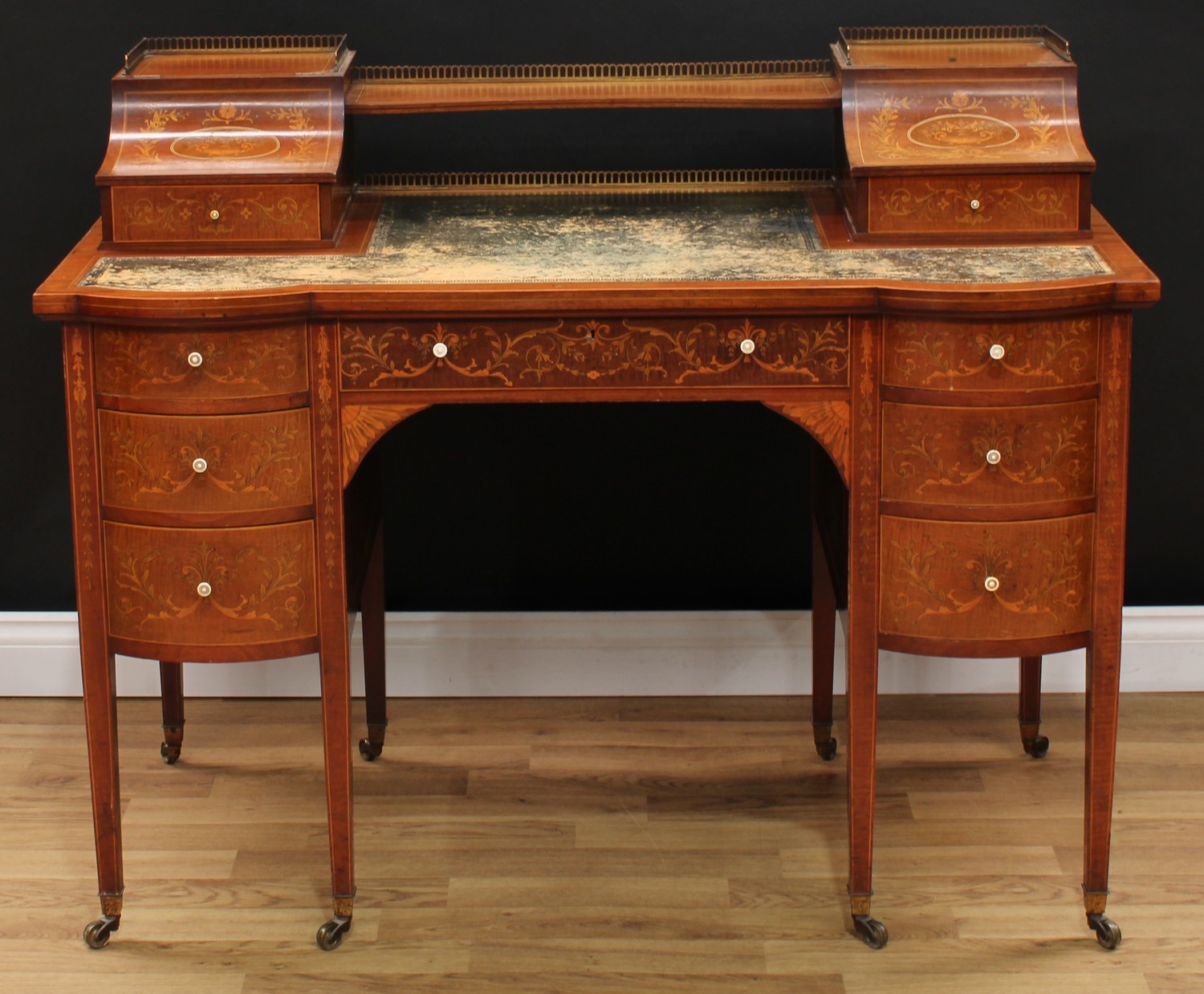 A late Victorian Sheraton Revival mahogany and marquetry writing desk, shaped superstructure with