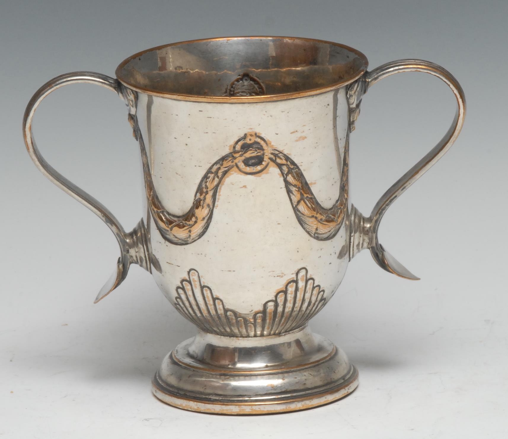 A George III Old Sheffield Plate loving cup, hal-fluted and chased with swags, scroll handles with