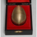 Stuart Devlin (1931 - 2018) - an Elizabeth II silver-gilt and silver surprise egg, Little Jack