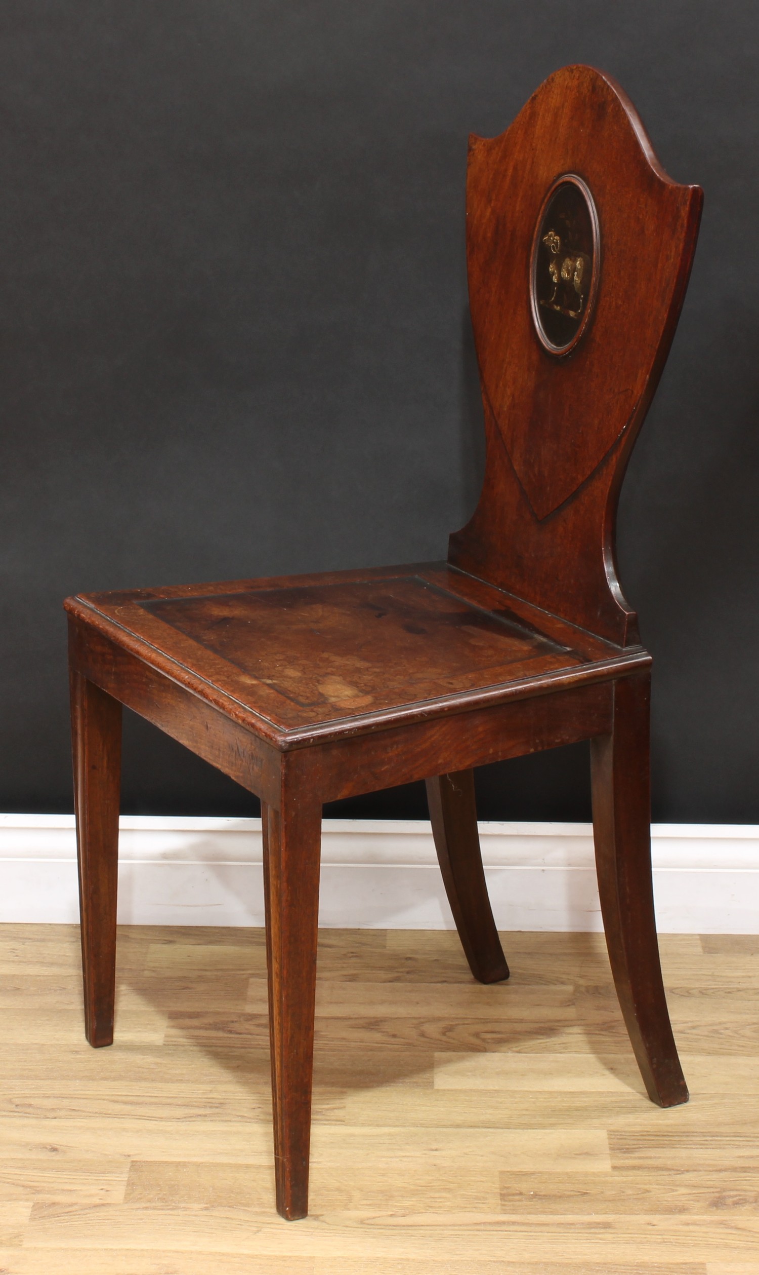 A George III mahogany Heraldic hall chair, shield shaped back with painted oval reserve, panel seat, - Image 4 of 5