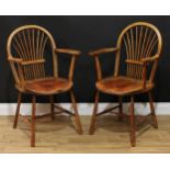 A pair of 19th century sheaf-back elbow chairs, of Windsor chair construction, hoop backs, saddle