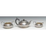 A composed George IV and early Victorian silver three piece half-fluted compressed globular tea