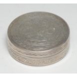 An Egyptian silver circular box and cover, engraved with scrolling leaves, 5.5cm diam