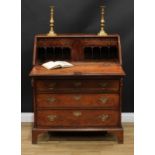 A George III oak bureau, fall front enclosing a yew veneered interior with a small door, small