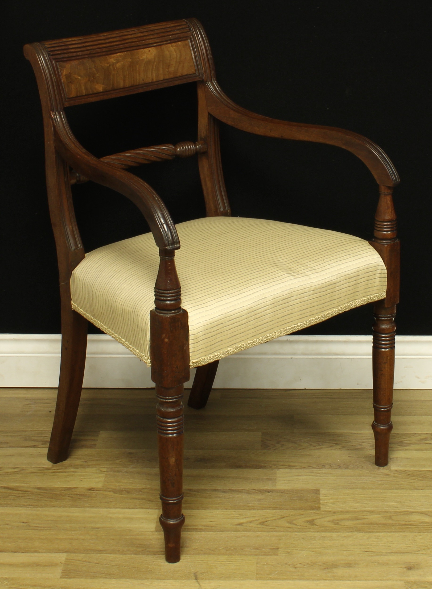 A George IV mahogany desk chair, reeded curved rectangular cresting rail, rope-twist mid rail,