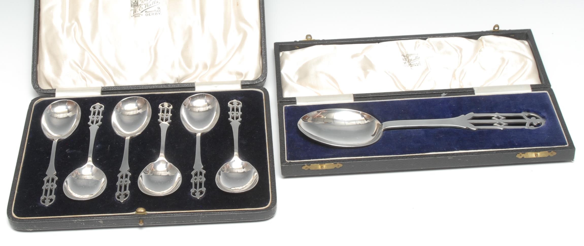 A set of six Arts and Crafts silver fruit spoons, pierced stems, W E Watts of Derby, Birmingham
