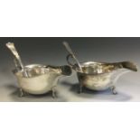 A pair of George III style sauce boats, pad feet, wavy rims, Trefid spoons ensuite, Horace