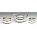 A George III Scottish silver three piece boat shaped tea service, comprising teapot, milk jug and