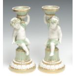 A pair of Minton figural Sevres style candlesticks, campana shaped sconces, the columns with